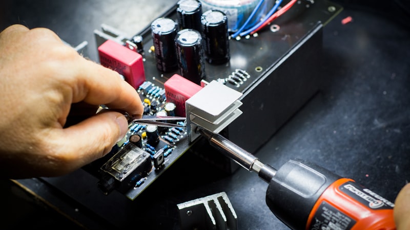 Technician working on electronics with a screwdriver